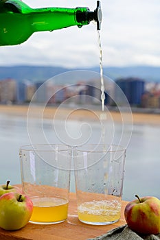 Pouring of natural Asturian cider made fromÂ fermented apples in wooden should be poured from great height for air bubbles